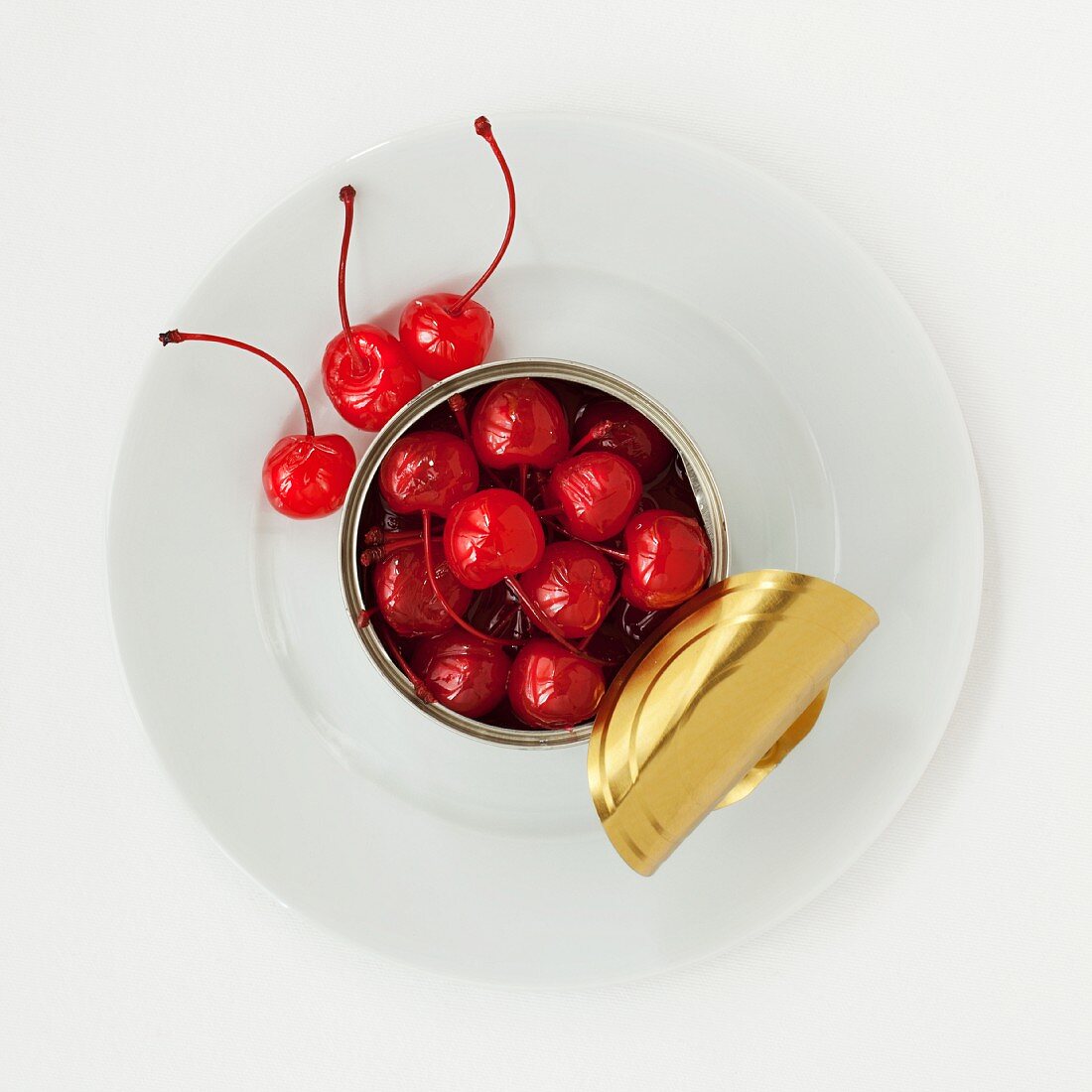 An opened tin of cocktail cherries