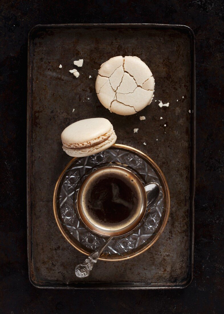 A cup of strong black coffee served with coffee macaroons