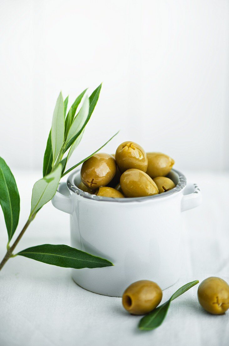 Green olives in a small ceramic bowls