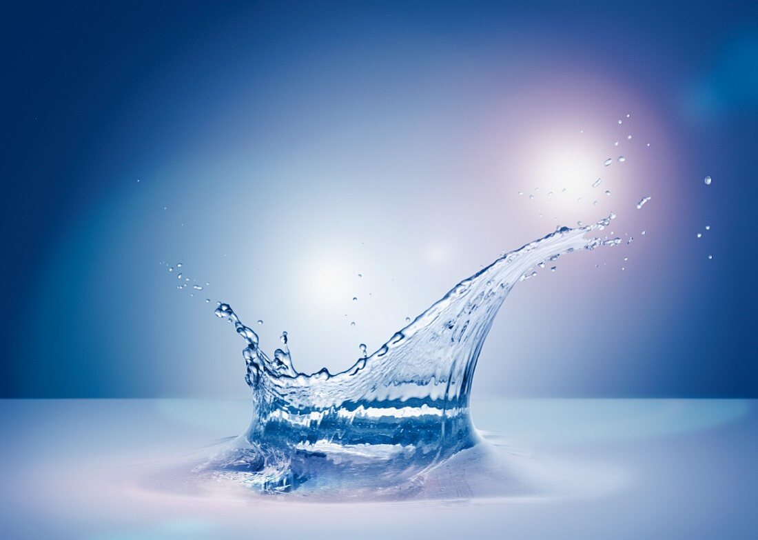 A backlit splash of water
