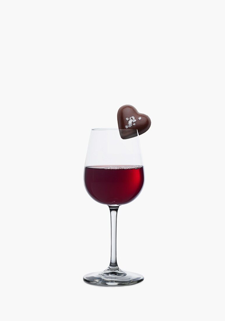 Herzpraline auf einem Rotweinglas