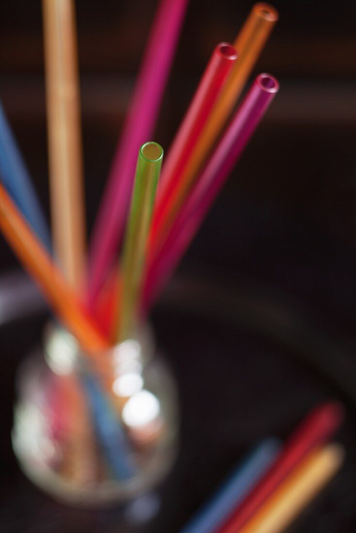 Coloured straws in a glass