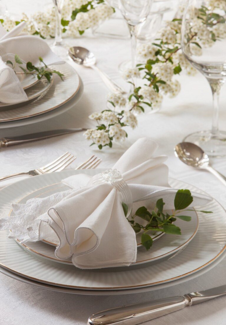 A spring wedding table set with white flowers