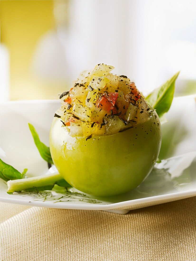 A green tomato filled with tomato tartar and green tea