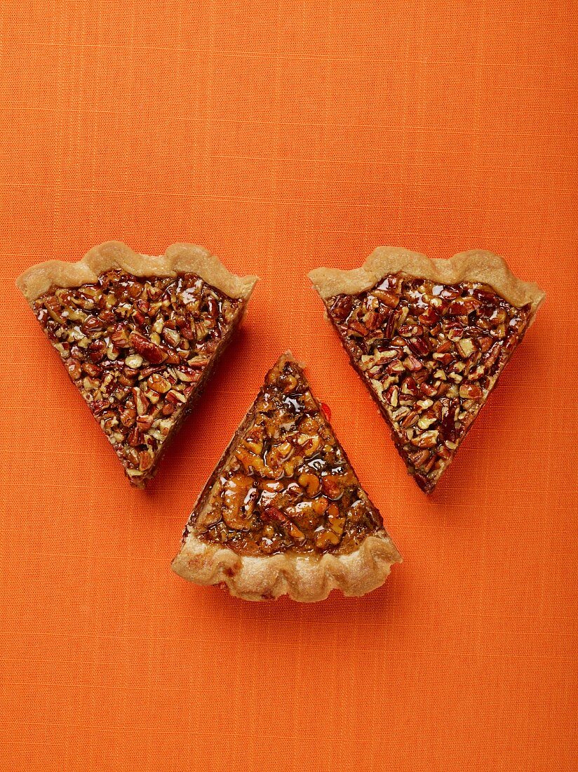 Three slices of pecan pie (seen from above)