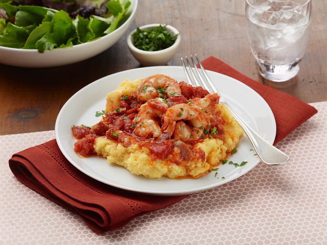 Polenta with shrimps, bacon and tomatoes