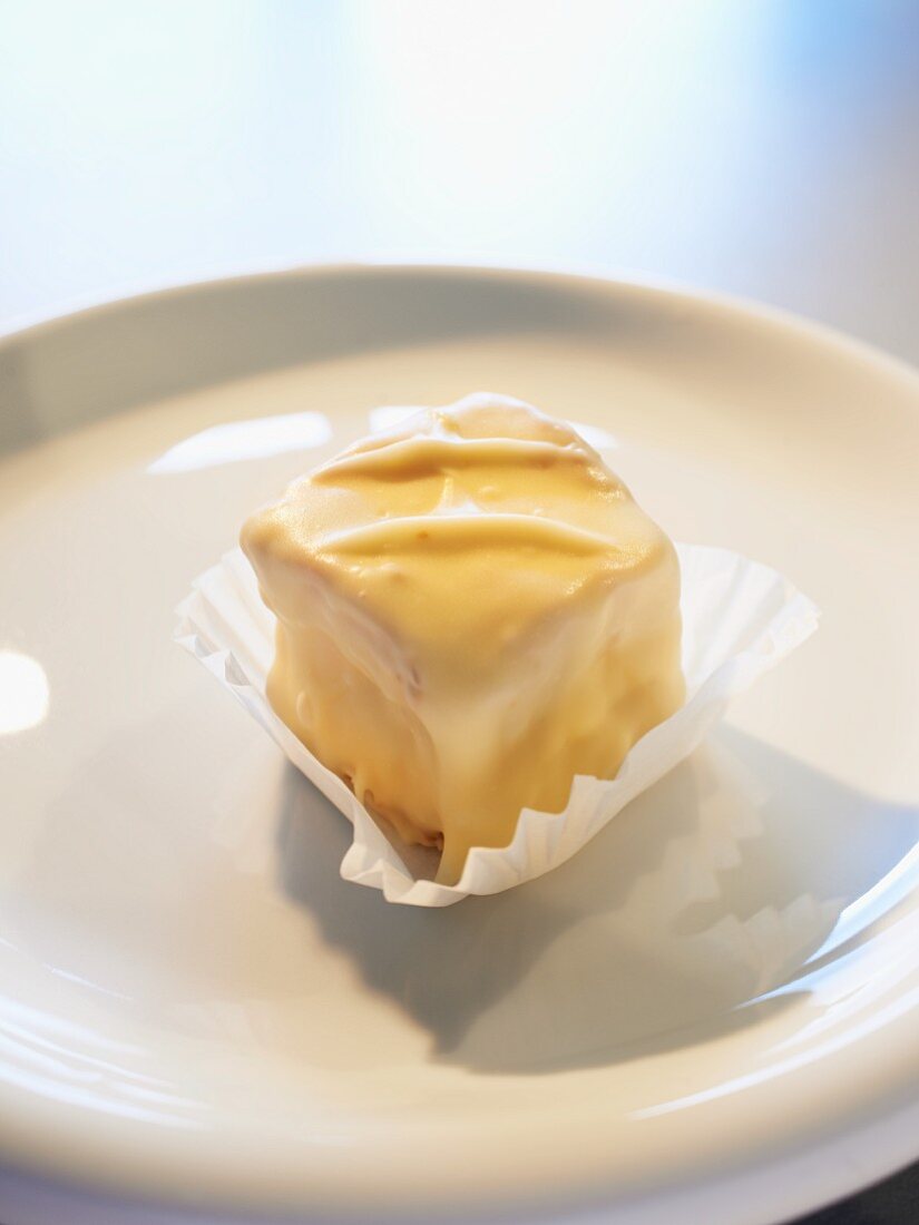 A blondie, mini cake with white chocolate glaze