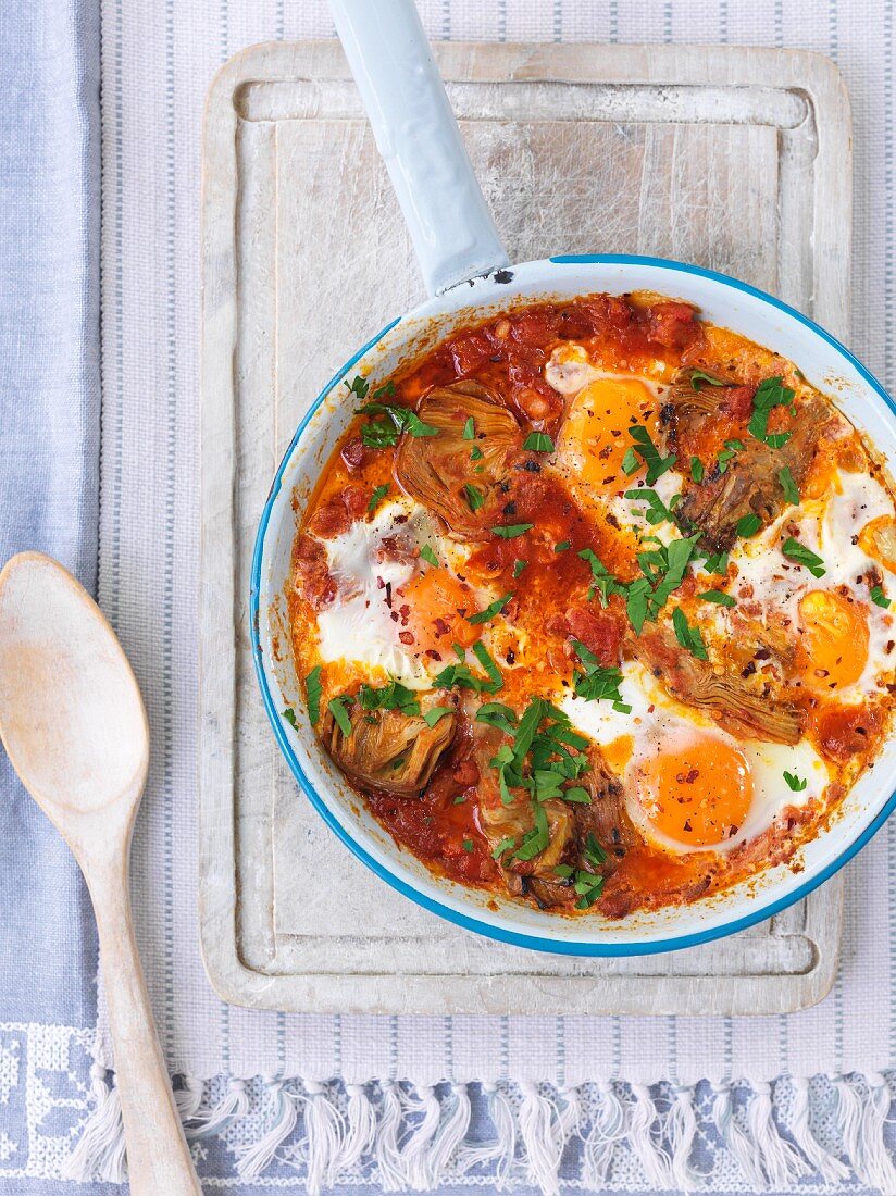 Poached eggs in a tomato and vegetable sauce