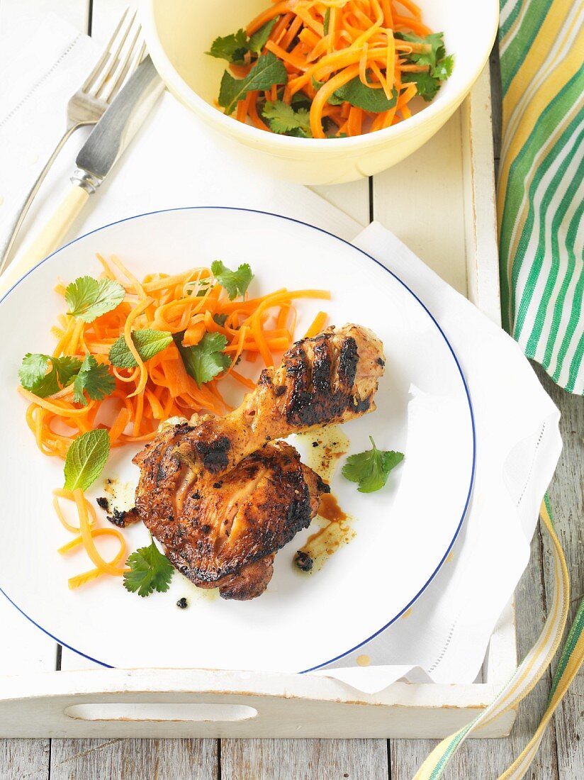 Marinated grilled chicken legs with carrot salad