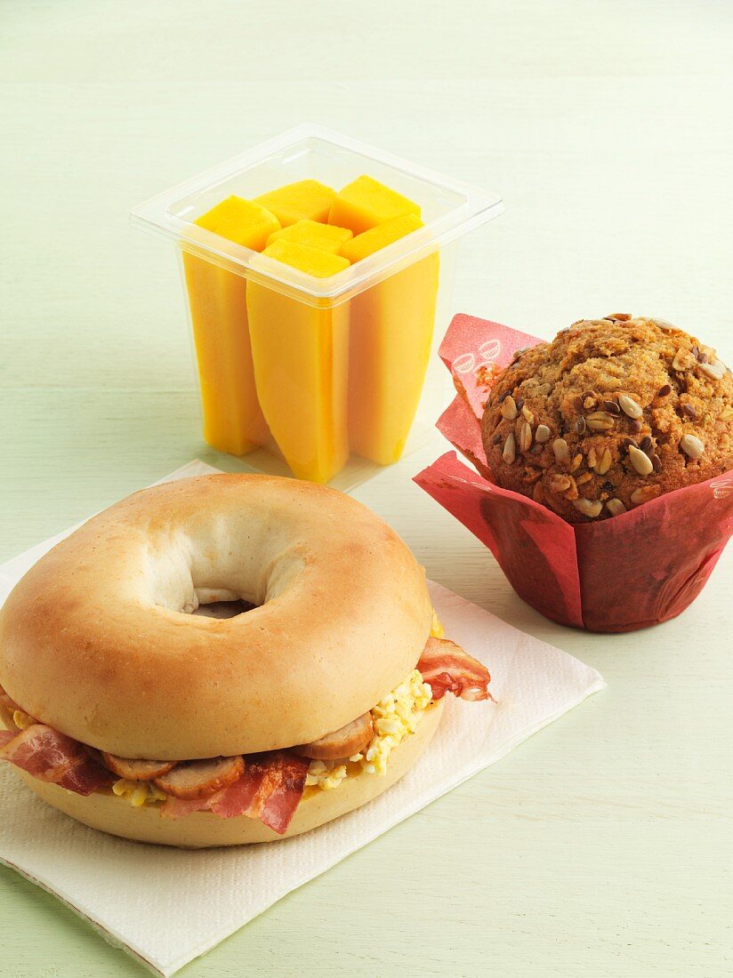 Bagel sandwich, muffin and fruit for breakfast