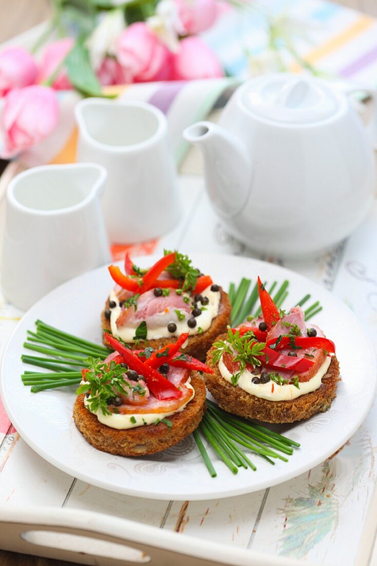 Canapes with smoked goose breast, red peppers and peppercorns