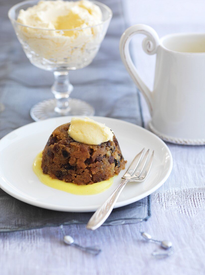 Christmas pudding with brandy butter and vanilla sauce