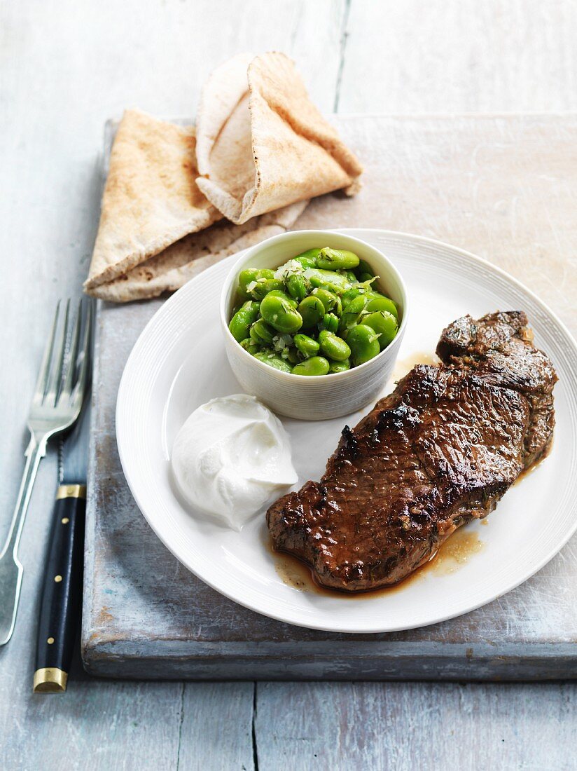 Marinated lamb steak with yoghurt and broad beans