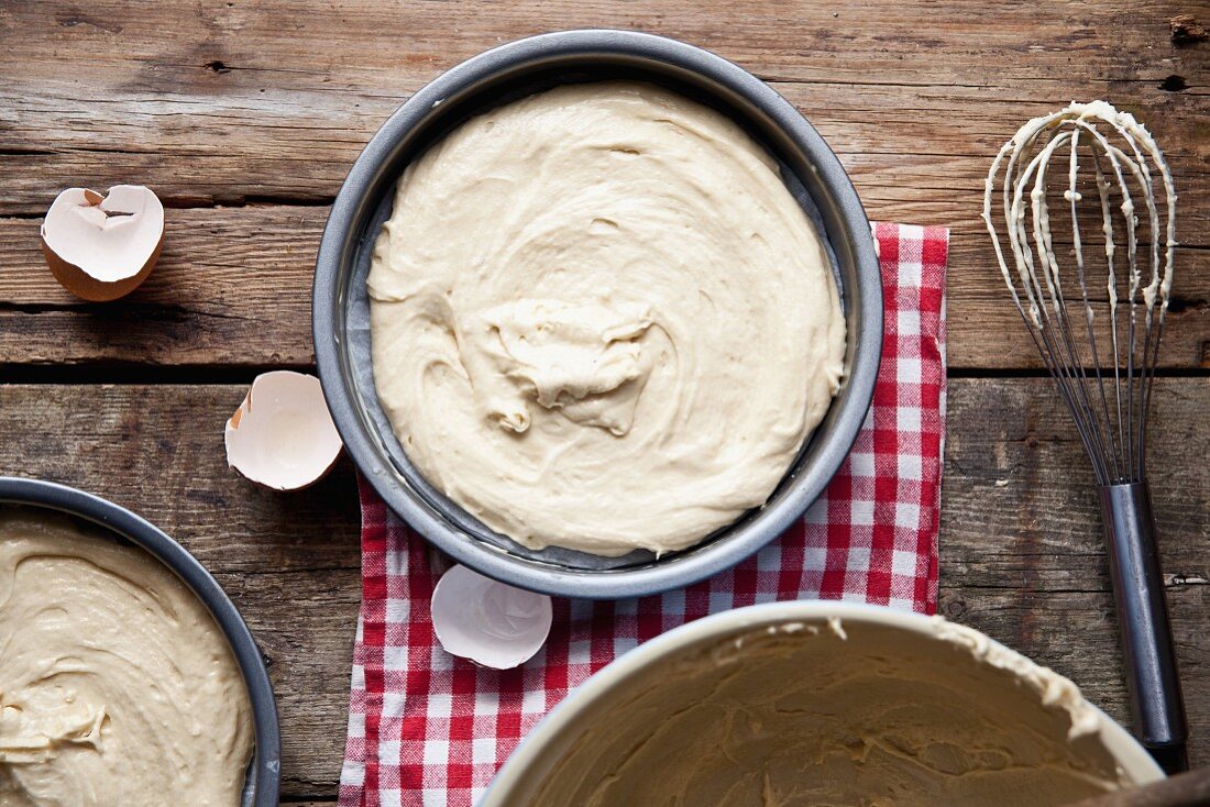 Raw sponge cake mix in a baking tin