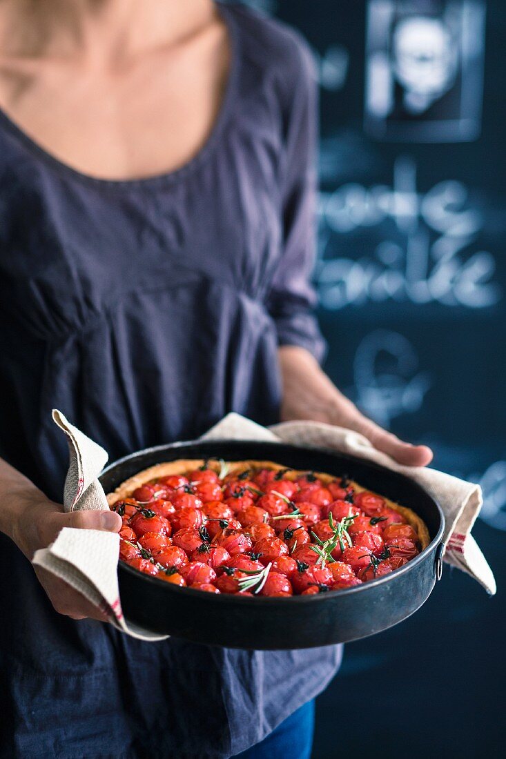 A cherry tomato tart in a baking tin