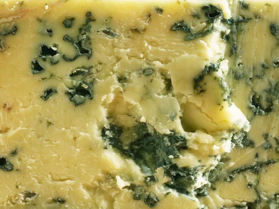 A close-up of a piece of Cropwell Bishop Stilton cheese