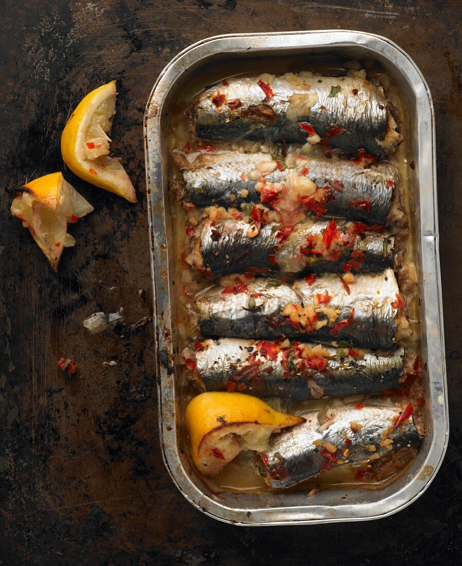 Baked sardines with chilli, garlic and lemon in an aluminium tray