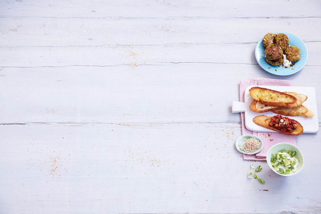 A mini buffet featuring lentil and leak cakes and aubergine crostini