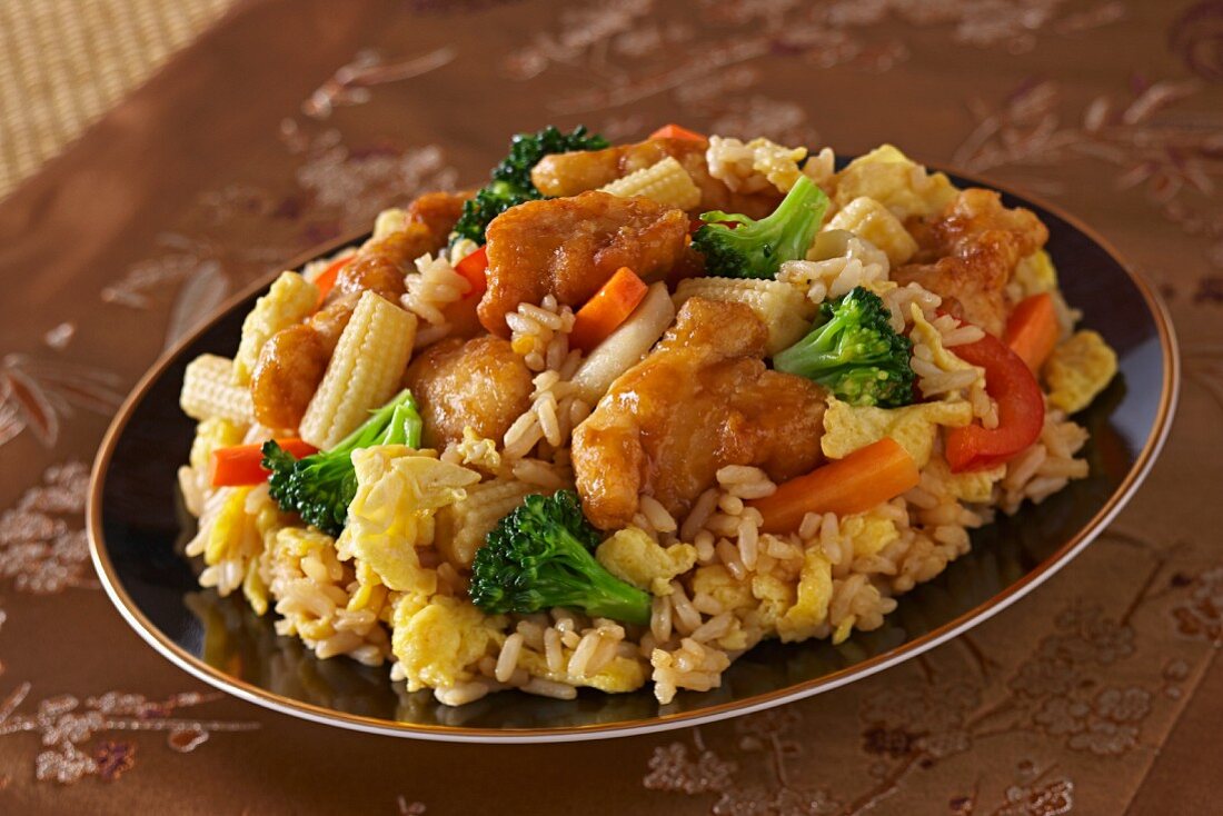 Chicken Stir Fry Over Rice in a Green Bowl; Chopsticks