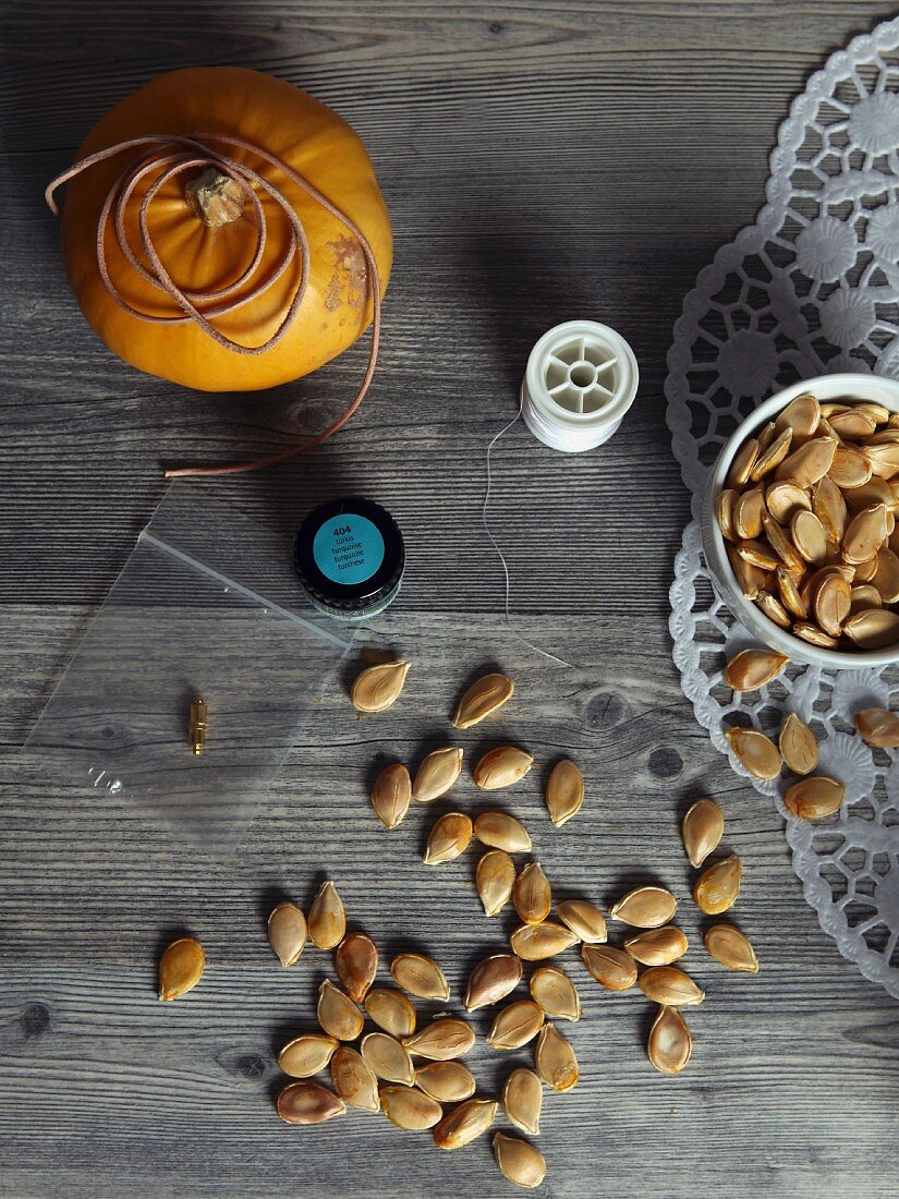 Pumpkin seeds and nylon thread: craft materials for making a pumpkin-seed garland