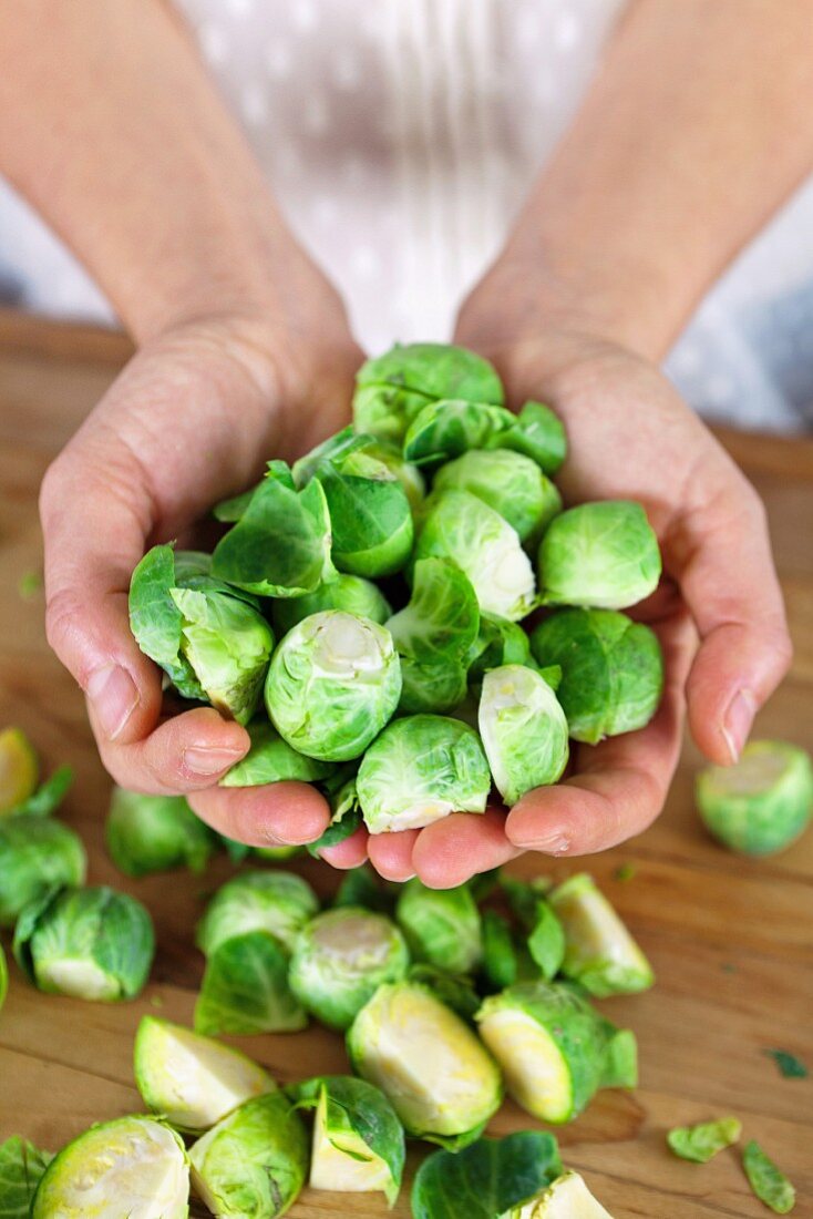 Hands holding Brussels sprouts