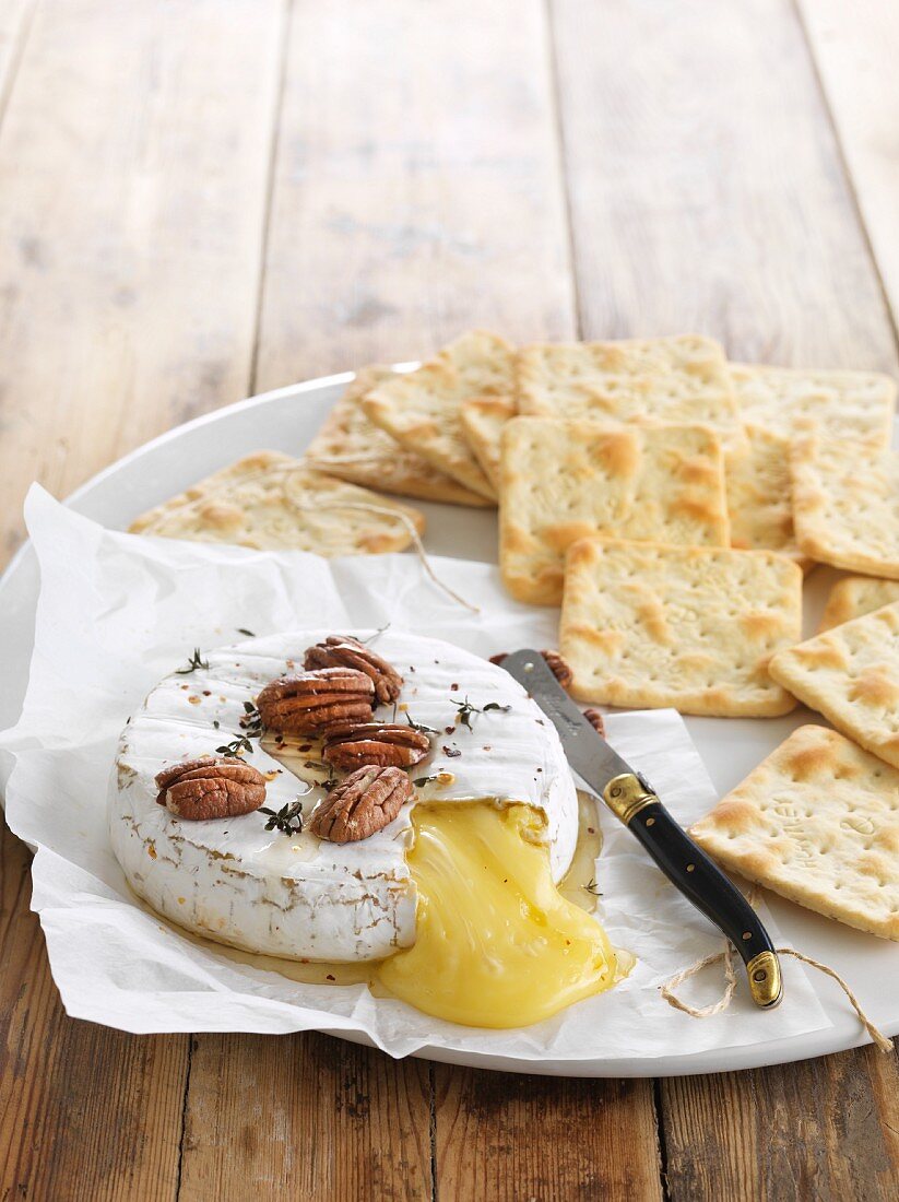 Baked Camembert with crackers and pecan nuts