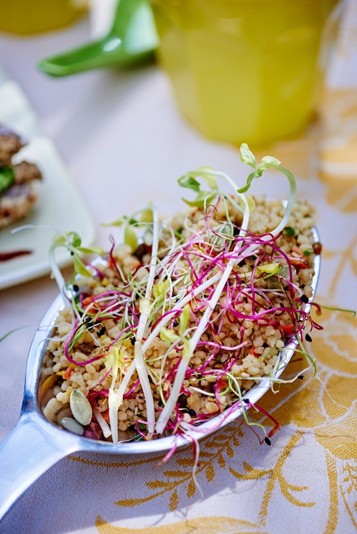 A spoonful of grain salad with bean sprouts
