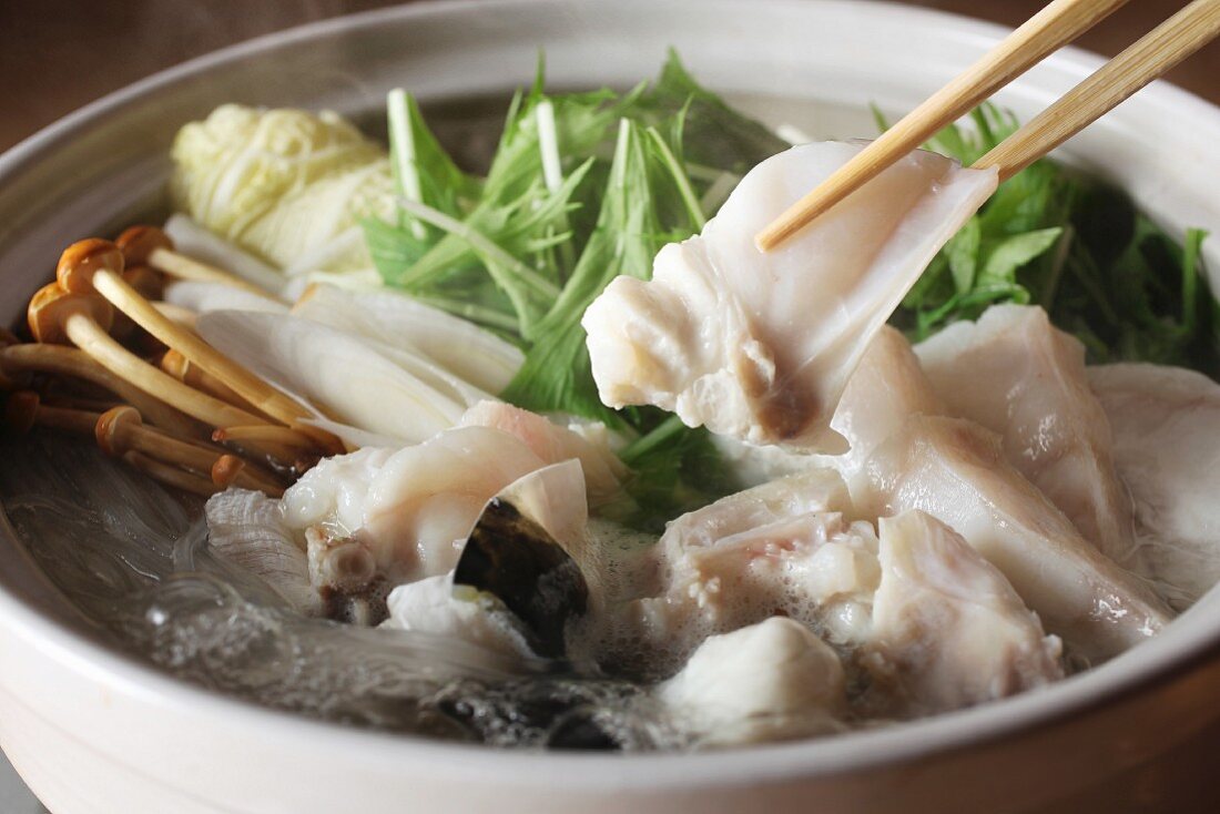 Japanese hot pot with cod, vegetables and mushrooms