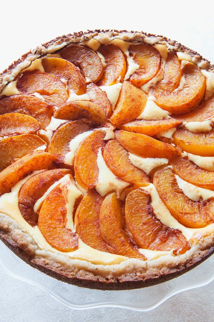 Peach tart on a cake stand