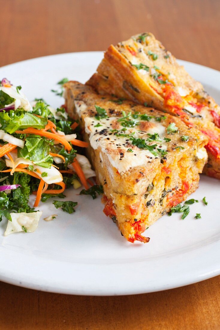 Panini with tomatoes, mozzarella, egg, parsley and a side salad