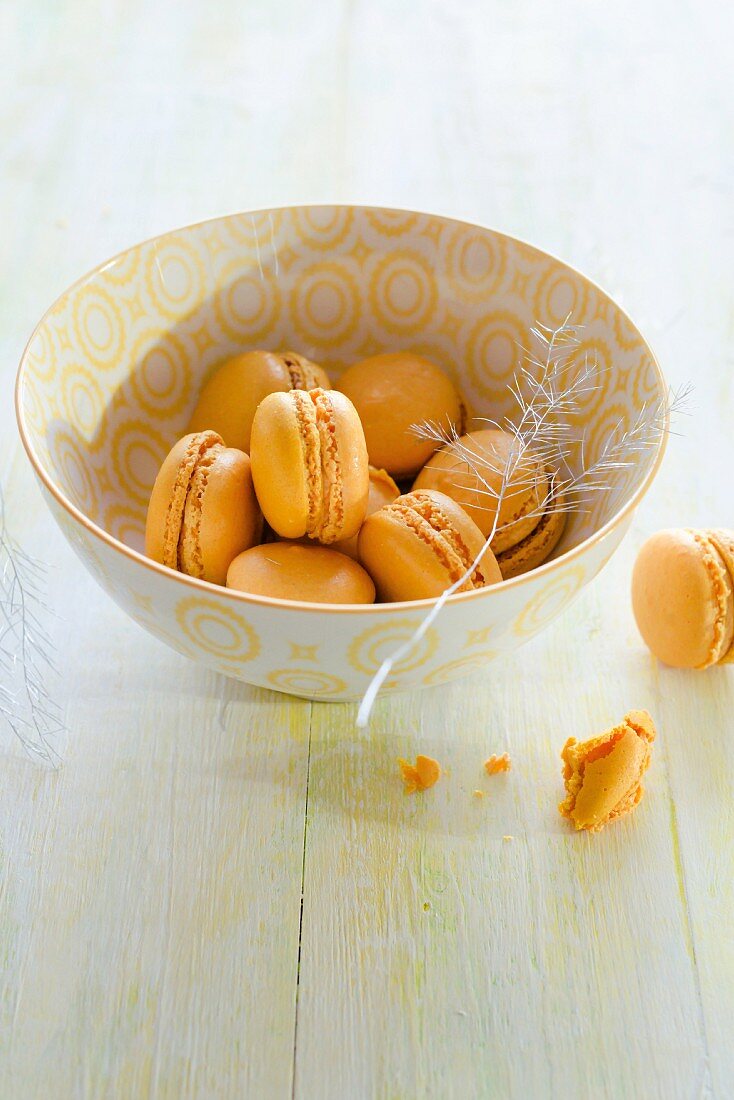 A bowl of orange macaroons