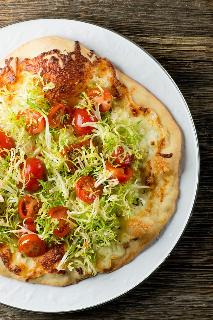 A cheese pizza with salad