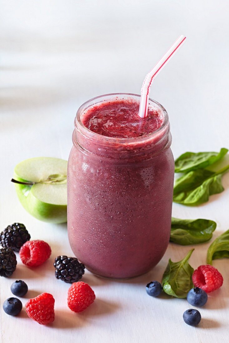 Smoothie made from three different berries, apples and basil