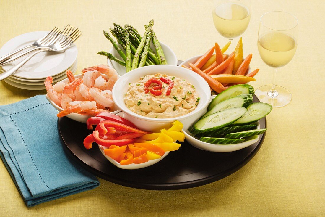 Pepper dip with prawns and raw vegetables in bowls