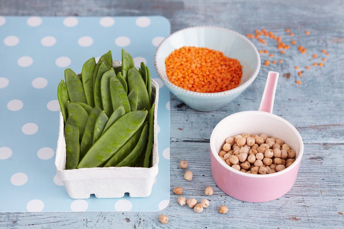 An arrangement of legumes: mange tout, lentils and chickpeas