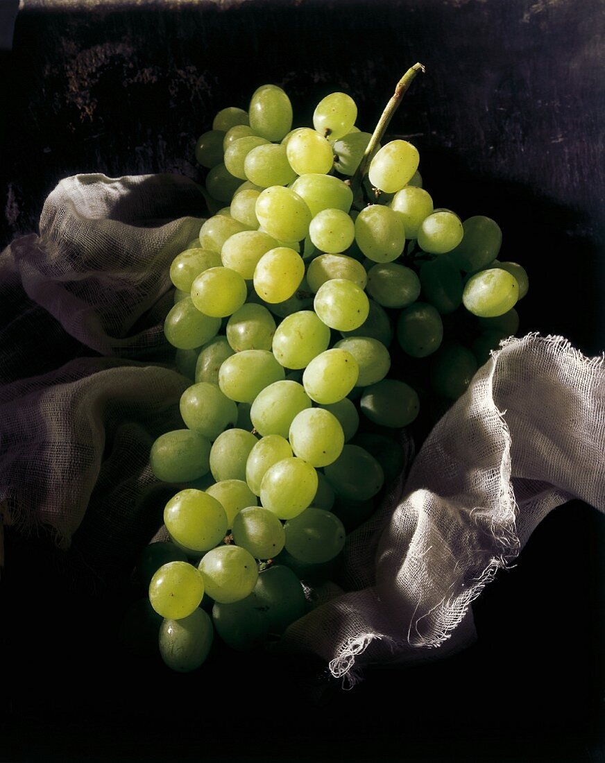 Green grapes on a piece of muslin