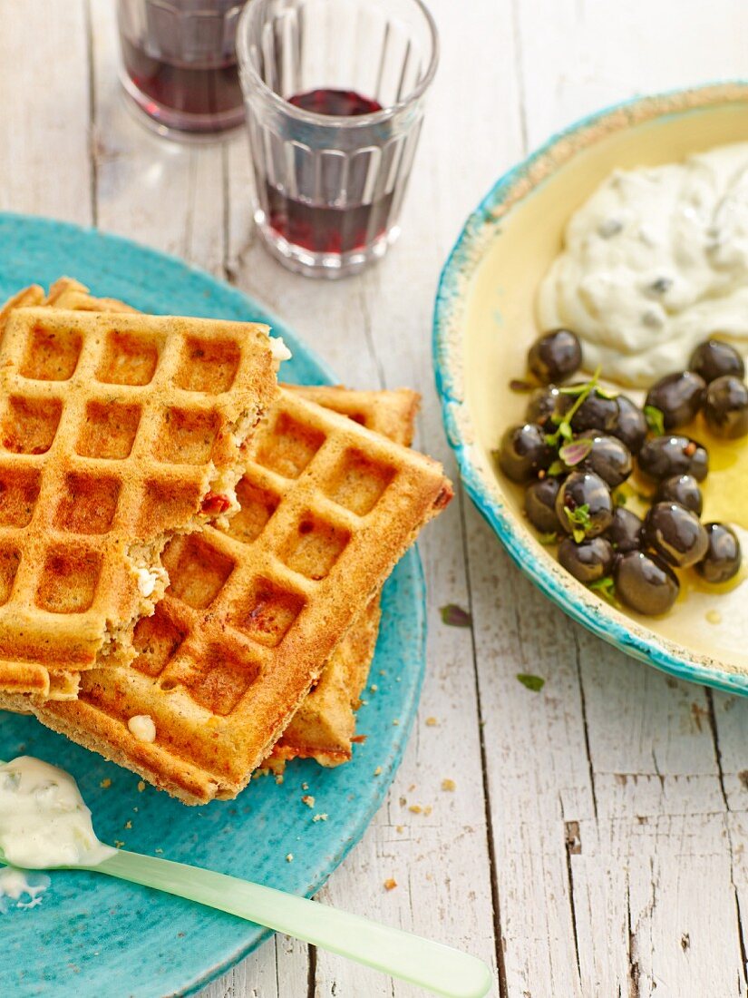 Feta cheese waffles served with olives and tzatziki