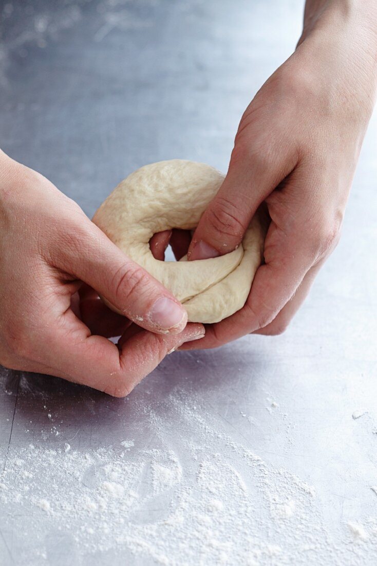 Dough being shaped into a bagel