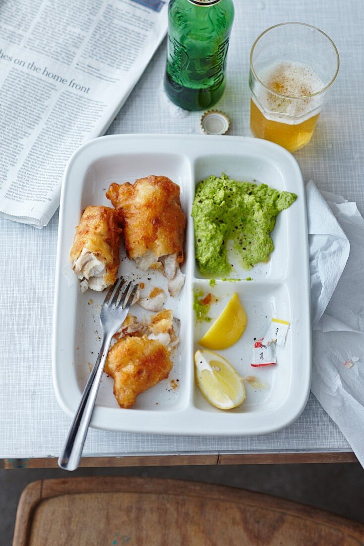 Fish and mushy peas on a three section plate