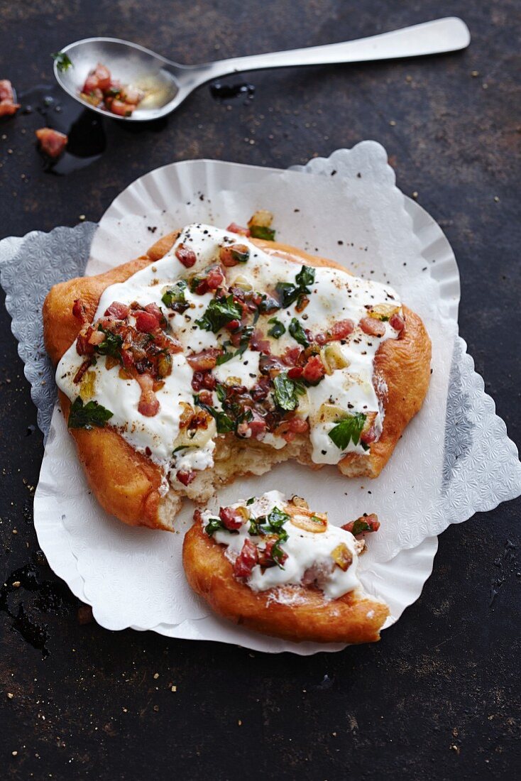 Langos (Hungarian bread) with creme fraiche, bacon and garlic oil