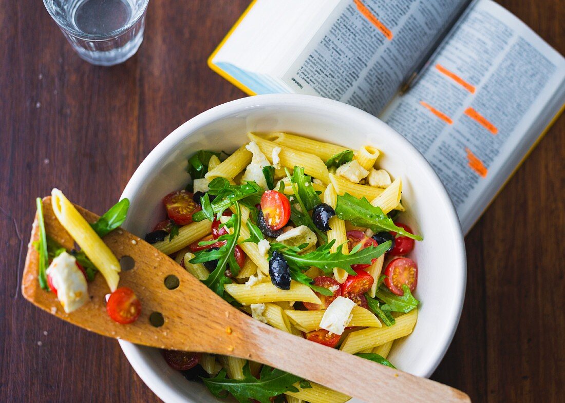 Pasta salad with rocket, cherry tomatoes and feta cheese