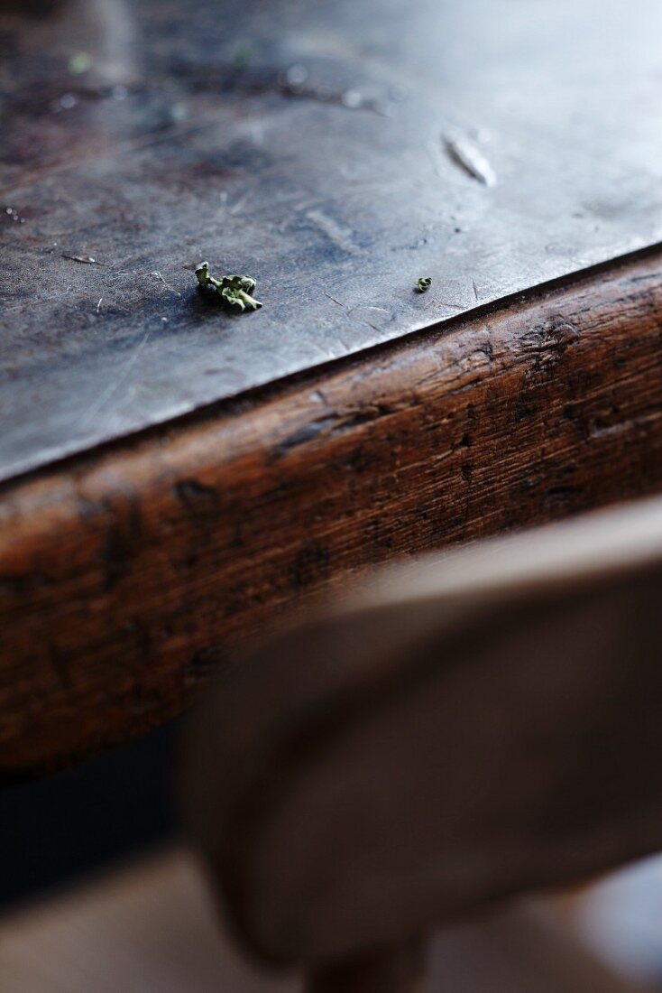 The remains of food and the edge of a plate on a wooden table