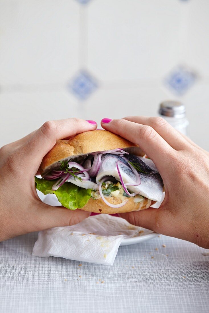 Hands holding a fish roll