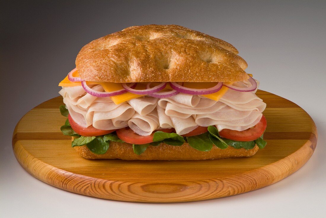 Turkey ham, cheese, onions and tomatoes on a ciabatta roll