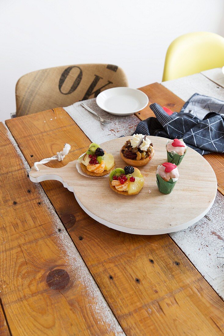 Cakes on wooden board or rustic wooden table