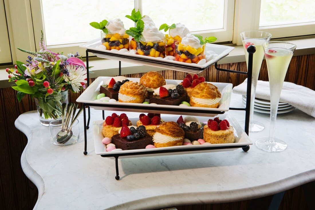 Various tartlets and profiteroles on a cake stand