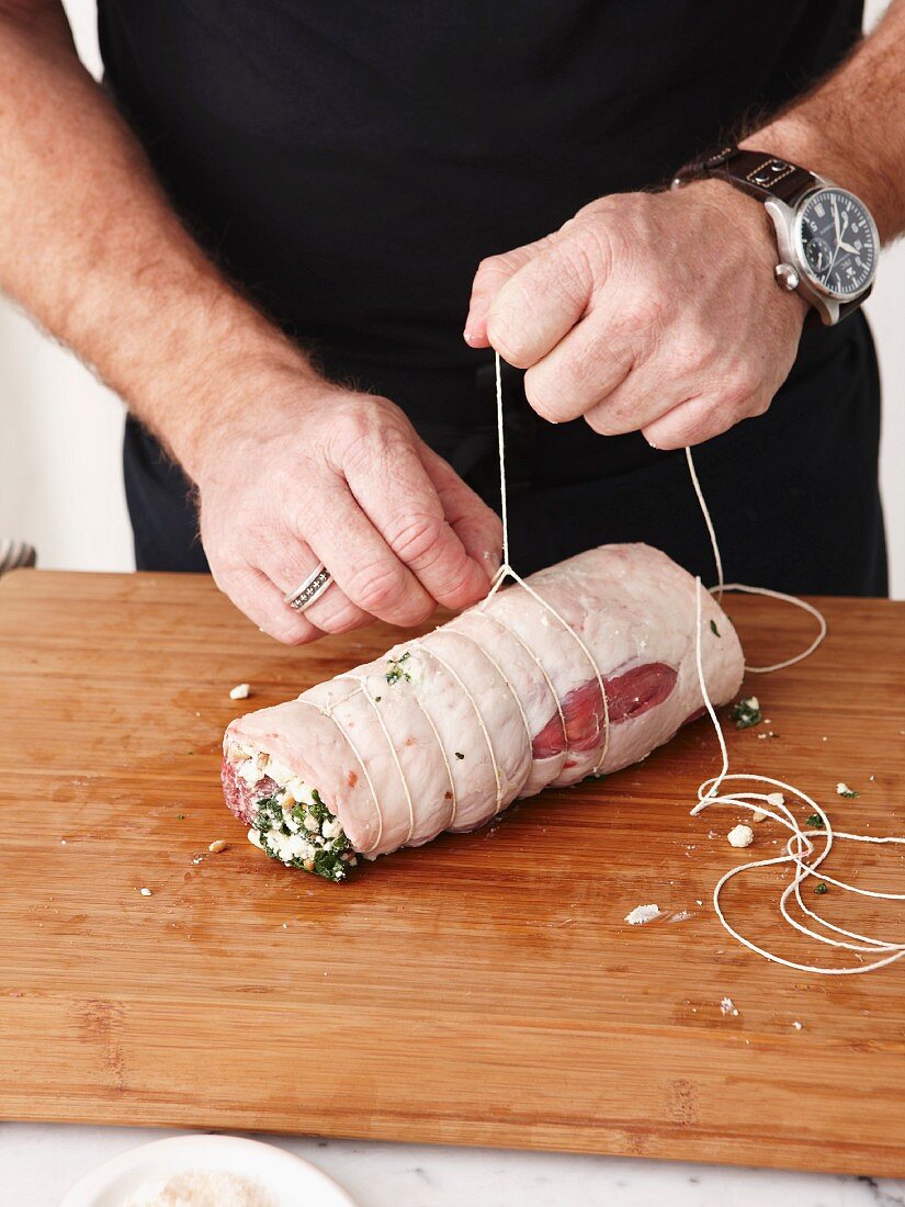 Stuffed lamb roulade being made