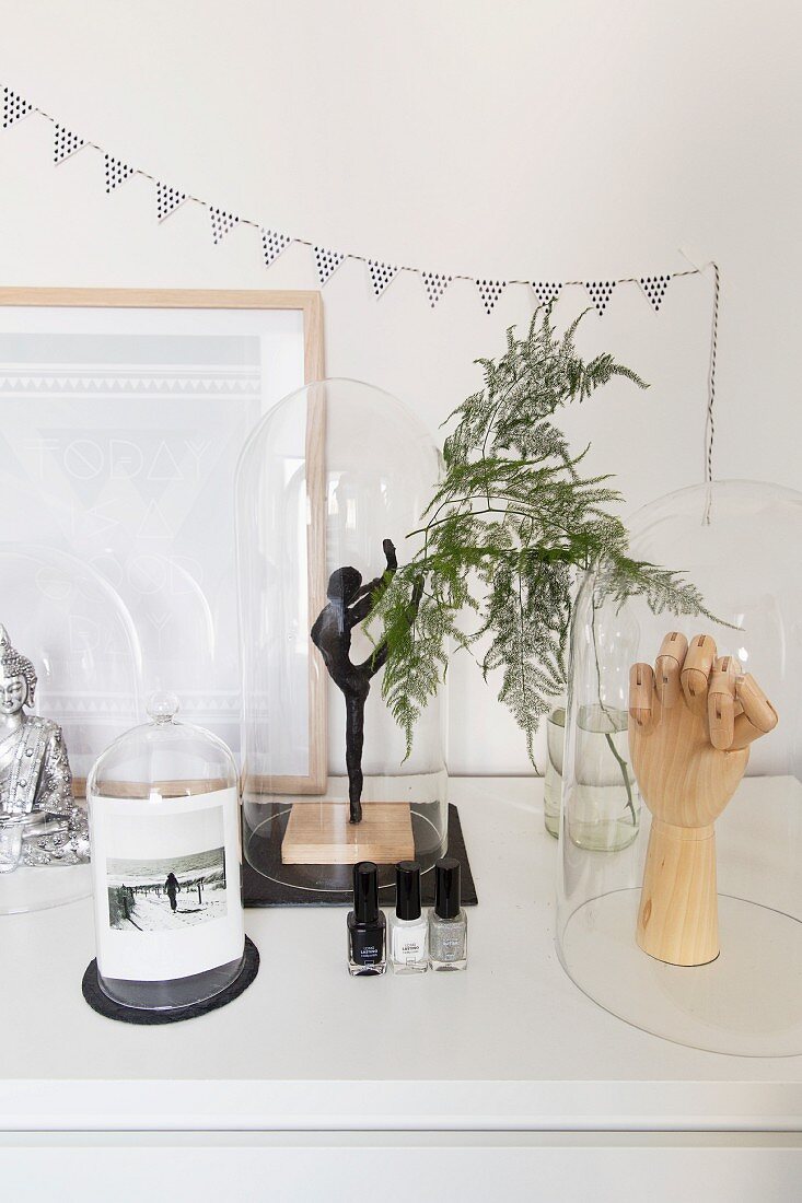 Figurine of dancer, wooden hand and photo under glass covers