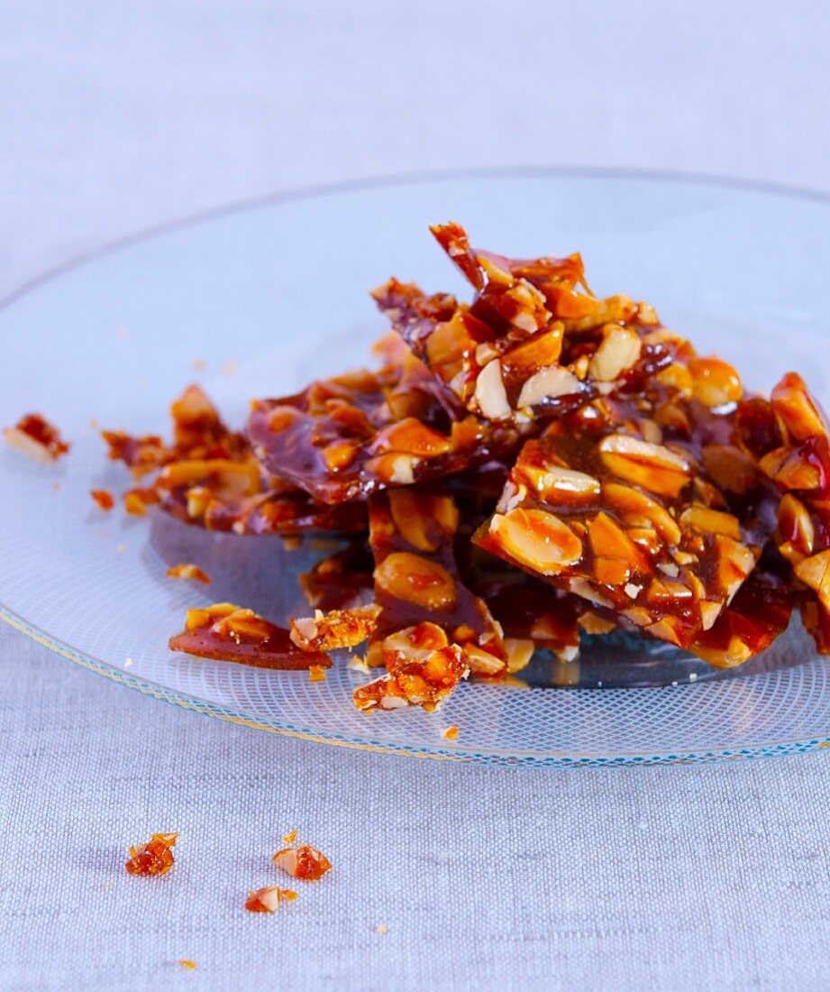 Peanut brittle on a glass plate