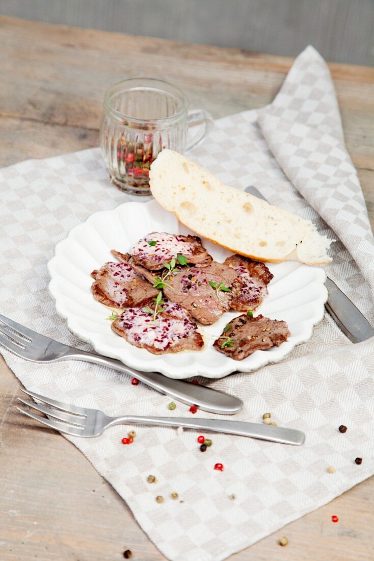 Peppered pork fillets with a Port wine and thyme butter on a hot stone